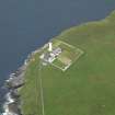 Oblique aerial view centred on the lighthouse with the keepers' cottage adjacent, taken from the N.