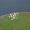 Oblique aerial view centred on the lighthouse with the keepers' cottage adjacent, taken from the NW.