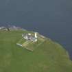 Oblique aerial view centred on the lighthouse with the keepers' cottage adjacent, taken from the W.