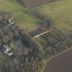 Oblique aerial view centred on the farmhouse with the walled garden and coach house adjacent, taken from the NW.