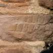 Detail of carved stone with incised diagonal design set into south wall of church