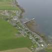 Oblique aerial view centred on the village with the pier adjacent, taken from the WNW.