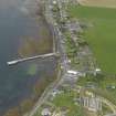 Oblique aerial view centred on the village with the pier adjacent, taken from the E.