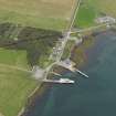 General oblique aerial view centred on the viallge with the harbour adjacents, taken from the S.