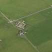 Oblique aerial view centred on the farmhouse with the farmstead adjacent, taken from the ENE.