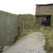 General view showing steps to lower section and magazines with gun emplacement in the background from the N.