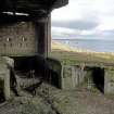 Detail of part of gun pit showing lower entrance, vertical magazine shaft entrance and a ready use ammunition locker, taken from the SW.