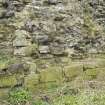 Detail of surviving section of 16th century wall showing rubble infilling and lower two course of faced blocks from SE.