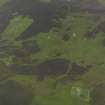 Oblique aerial view centred on the remains of the farmsteads, field systems and head dykes, taken from the SW.