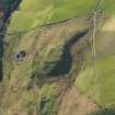 Oblique aerial view centred on the remains of the fort at Largiemore, taken from the NE.