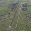 Oblique aerial view of Machrihanish Airfield looking along the runway, taken from the WNW.