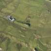 Oblique aerial view of the dun and Pennyseorach farmstead, taken from the SE.