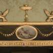 Interior. 1st floor, long drawing room, view of oval panel and decoration on mirror above fireplace