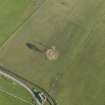 Oblique aerial view centred on the remains of the stone circle, taken from the NW.