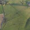 Oblique aerial view centred on the remains of the coal pit, track and rig and furrow, taken from the W.