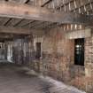 Interior view, looking along the S side of the dividing wall within the first floor of bonded warehouse (west section) at the former Rosebank Distillery.