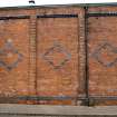 Detail of decorative brickwork on S wall of depot from S.