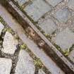 Detail of tram track, showing different directions of laid setts.