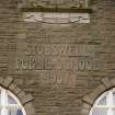 Detail of carved name and date in E facade of school from E.