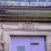 Detail of carved stone 'Boys' above E entrance, from S.