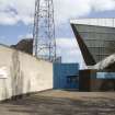 View of the grandstand at Meadowbank Stadium from the west, showing signage on the walls enclosing the stadium.