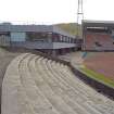 View of the east end of Meadowbank Stadium, showing bench seating, indoor centre, and grandstand.