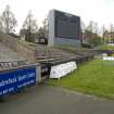 View of the west end of Meadowbank Stadium from the southeast, showing the bench seating and dot matrix scoreboard.