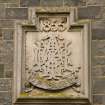 Detail of carved date panel monogram of Captain Alexander Mitchell-Innes.