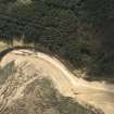 Oblique aerial view centred on the road block, taken from the NNE.