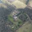 Oblique aerial view centred on the country house with the stables adjacent, taken from the SW.