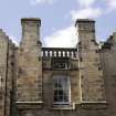 Detail of upper storey window and wallhead, with flanking wallhead chimneys, on south east elevation
