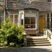 View of bay window and entrance door, with south east terrace to fore, taken from south east