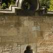 Detail of trefoil vent and circular wallhead ornament within rear court wall