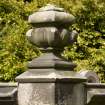 Detail of damaged stone urn finial on rear court wall