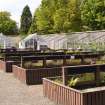 West section of garden, view with greenhouses from E