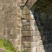 Detail of NW arch and abutment showing quoin stones.