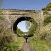 General view from SSE showing up and down platform edges and the road overbridge.  RCAHMS Field Surveyor D Easton.