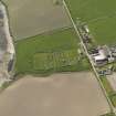 Oblique aerial view centred on St Nicholas' Church, Orphir with Bu of Orphir farmstead adjacent, taken from the ENE.