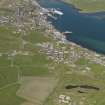 General oblique aerial view of Stromness with the Ness Battery in the foreground, taken from the WSW.