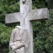 View of free standing cross and partially damaged sculpture.