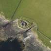 Oblique aerial view centred on Midhowe broch, Rousay, taken from the SW.