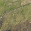 Oblique aerial view centred on the ruins of a farmstead at Mansemass Hill, taken from the SE.