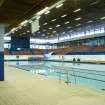 Interior view of Royal Commonwealth Pool, Edinburgh. View looking S across competition pool to spectator seating banks.