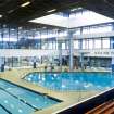 Interior view of Royal Commonwealth Pool, Edinburgh. Elevated view from spectator seating bank, looking NE to diving pool.