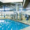 Interior view of Royal Commonwealth Pool, Edinburgh.  Elevated view from spectator seating bank, looking NW to diving platforms.