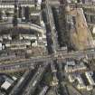 Oblique aerial view centred on Leith Walk with the site of the former tram and bus depot adjacent, taken from the SE.