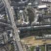 Oblique aerial view centred on part of  Leith Walk with the site of the tram and bus depot adjacent, taken from the NE.