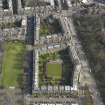 Oblique aerial view centred on the bowling green with tenements adajacent, taken from the W.