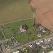 Oblique aerial view of the church with the churchyard adjacent, taken from the S.