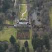 Oblique aerial view centred on the tower/country house with the garden adjacent, taken from the NE.